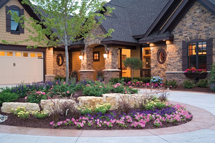 Front of home with flower bed and stones.