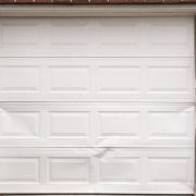 repair or replace dented garage door panel